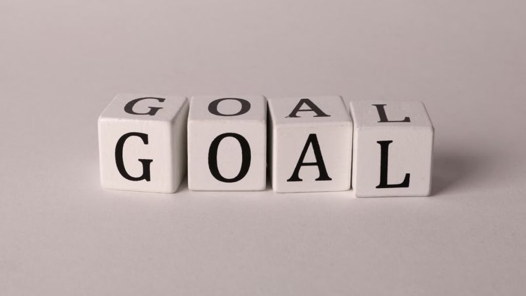 White letter blocks spelling 'Goal' on a neutral backdrop, ideal for business themes.